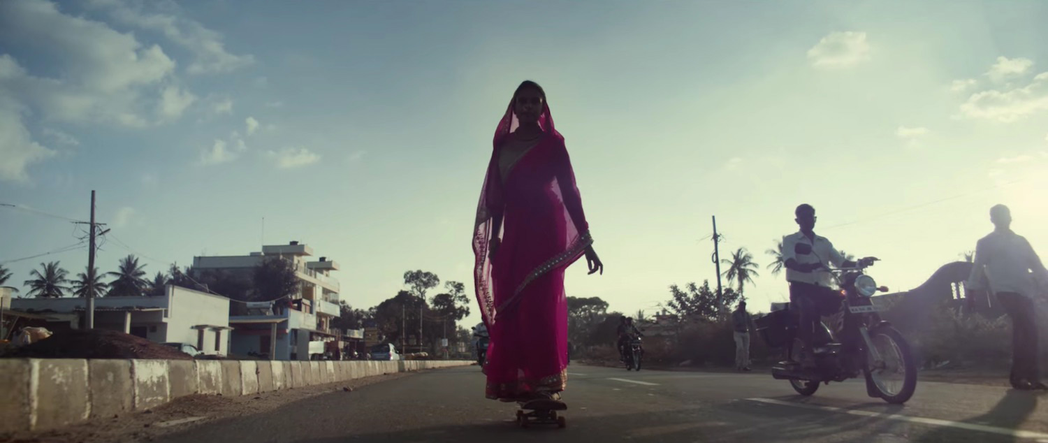 Indian skate culture woman skating through the streets of india