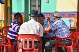 daily life in Guatape men with bowler hats
