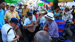 men playing music on a square in medellin