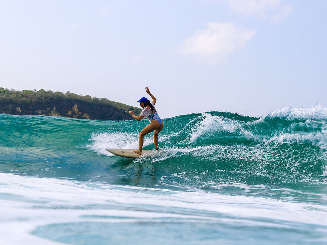 Girl surfing Gerupuk in Lombok Indonesia