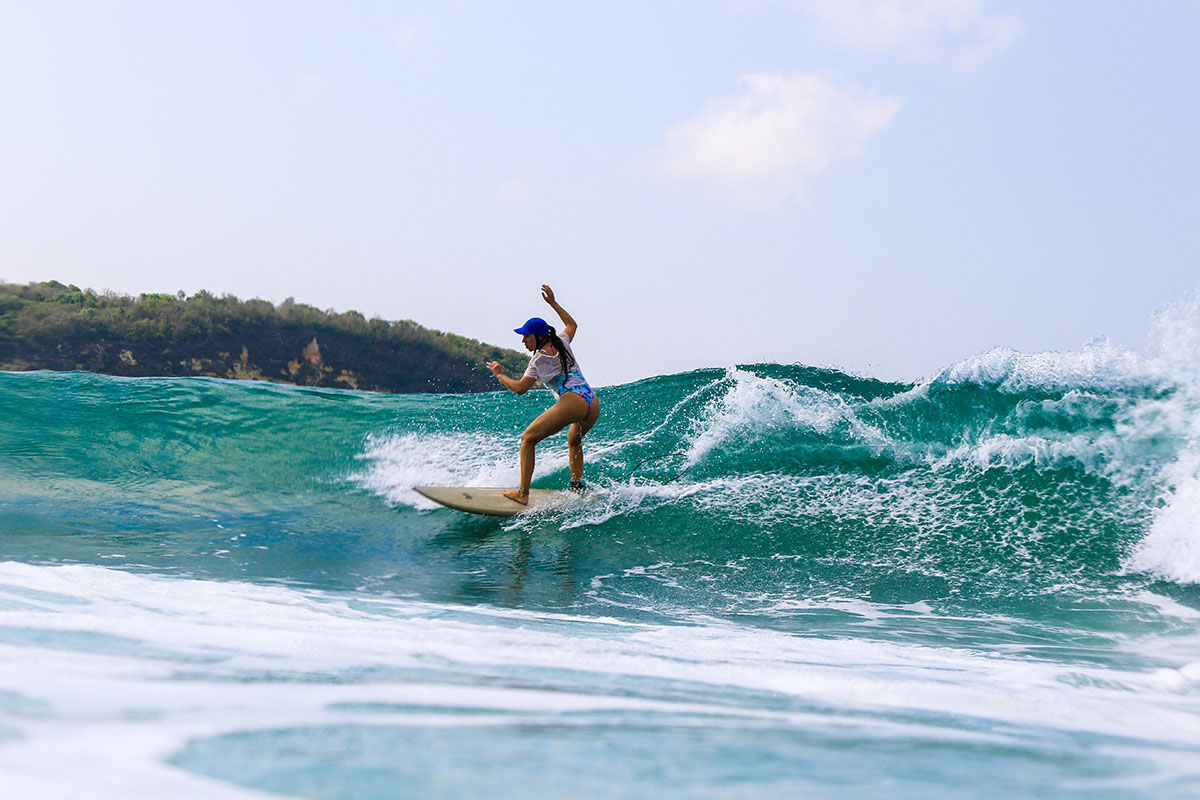 Girl surfing Gerupuk in Lombok Indonesia