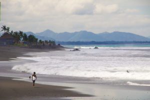 Surfer at Keramas beach in Bali