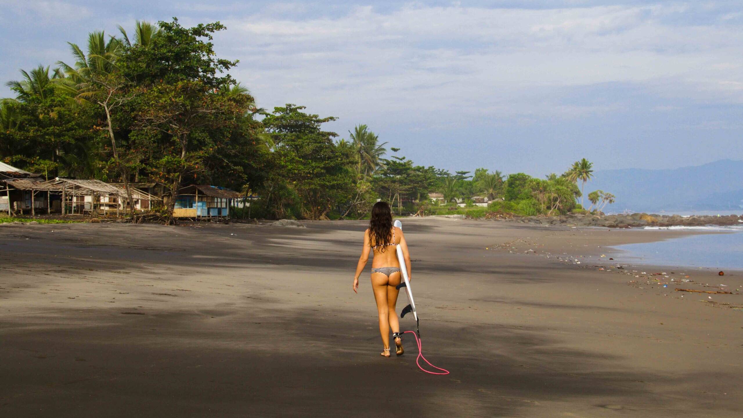 Surfer girl on Cimaja beach Java