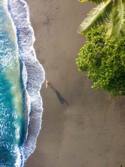 Surfer girl on the beach drone shot in Costa Rica