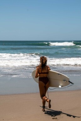 surf girl at Popoyo beach Nicaragua
