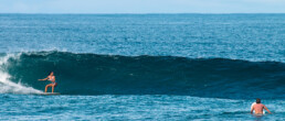 Surfer girl surfing Punta Banco wave in Costa Rica