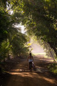 Surfer girl on a bicycle in Punta Banco Costa Rica