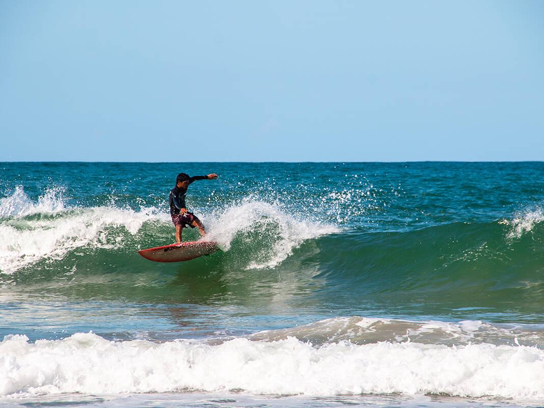 Surfer at Playa Cocles on the Caribbean Costa Rica