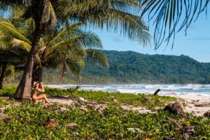 Sipping coconuts under a palm tree at Playa Santa Teresa in Costa Rica