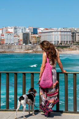 Girl and dog at the beach of A Coruña in Galicia