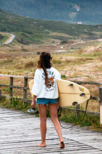 Surfer girl at Praia de Doniños