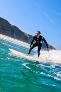 Surfer at Praia Magoito in Portugal