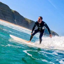 Surfer at Praia Magoito in Portugal