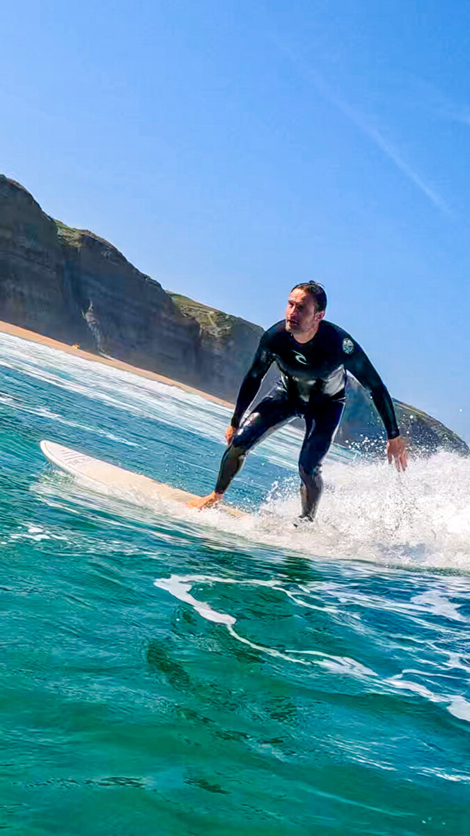 Surfer at Praia Magoito in Portugal