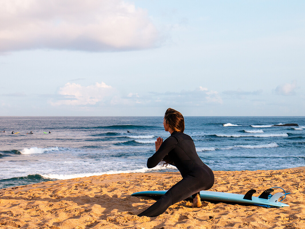 surf girl stretching at Ribeira D'Ilhas in Ericeira