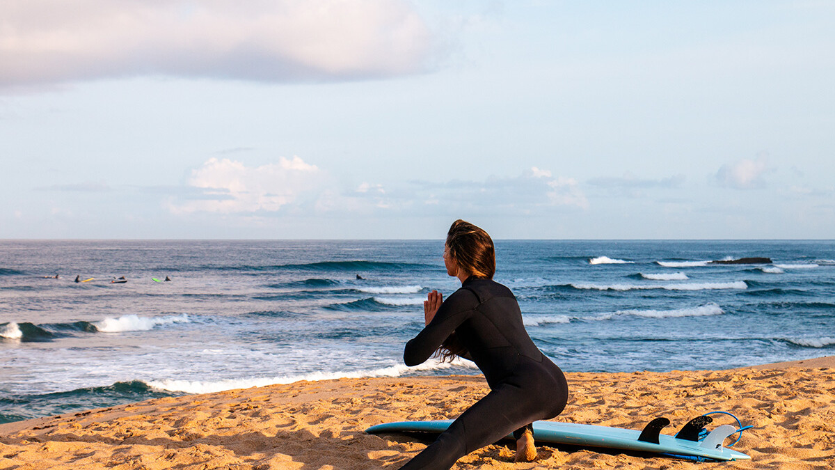 surf girl stretching at Ribeira D'Ilhas in Ericeira