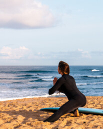 surf girl stretching at Ribeira D'Ilhas in Ericeira