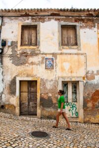 Girl strolling around Ericeira old town in Portugal