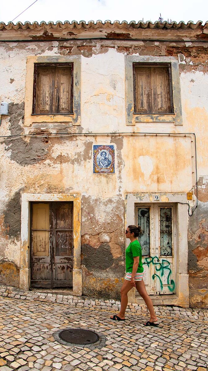 Girl strolling around Ericeira old town in Portugal