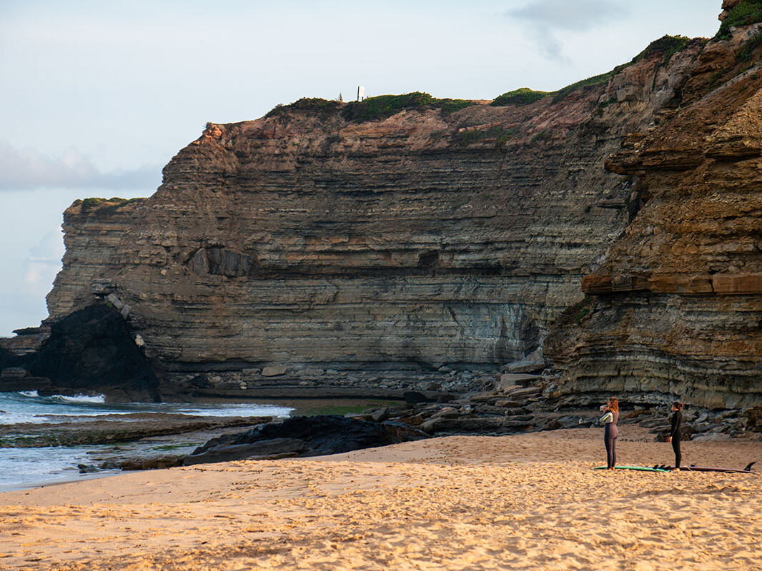 Surfers at Praia Sao Lourenco in Ericeira