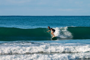 Surfer catching a wave at Mokum Surf Club Costa Rica retreat