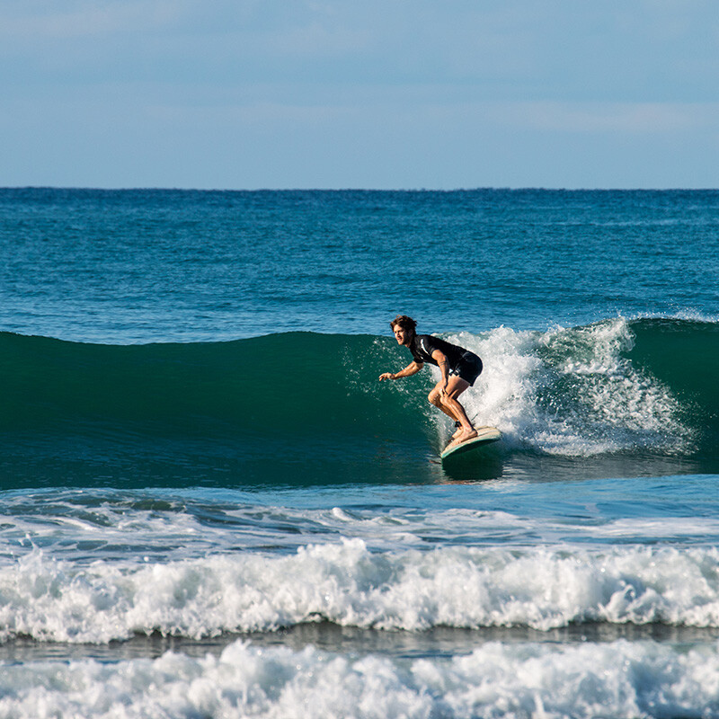 Surfer catching a wave at Mokum Surf Club Costa Rica retreat
