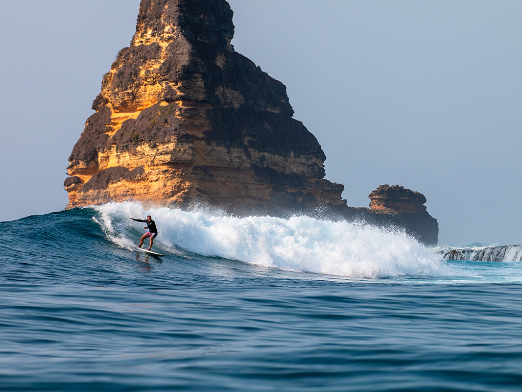 Surfer at Gerupuk Outside wave in Lombok