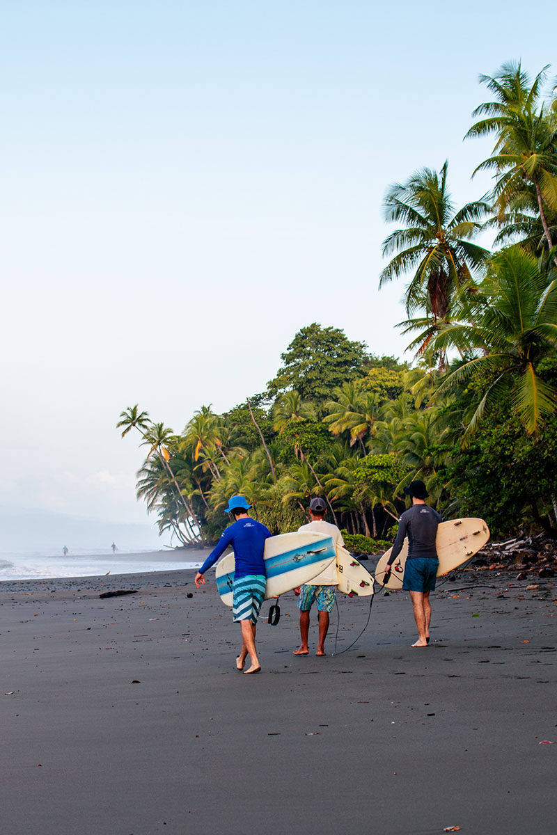 Surfers on the beach at sunrise during Mokum Surf Club Costa Rica retreat