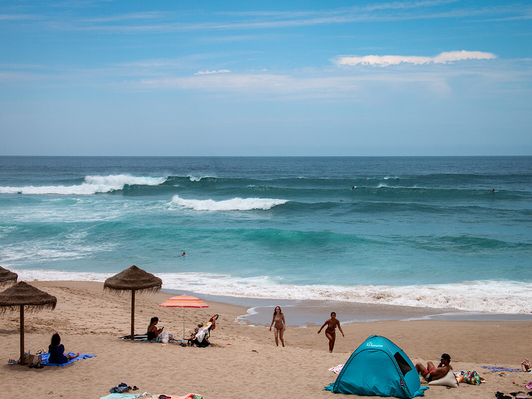 Surfers at Praia Grande beach on the Sintra coast near Lisbon